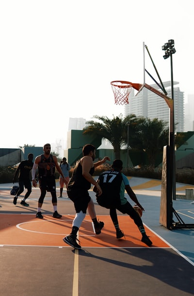 People play basketball during the day
